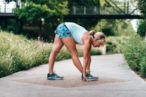 Runner stretching hamstrings